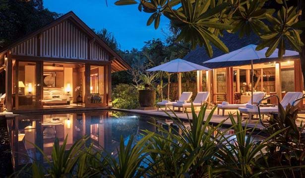 two bedroom beach villa with a private pool and sun loungers in the rainforest at night