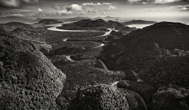 wide black and white photo showcasing the landscape of Langkawi with meandering river, rainforests and a mountain