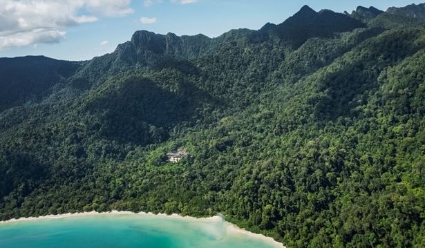 aerial view of the datai and the surrounding rainforest with the beach and and he ocean as well in a sunny setting