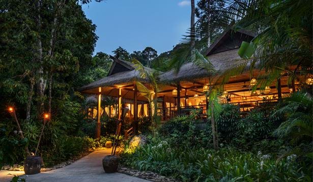 exterior shot of one the resorts restaurants the gulai house in the evening with a a path leading up to it