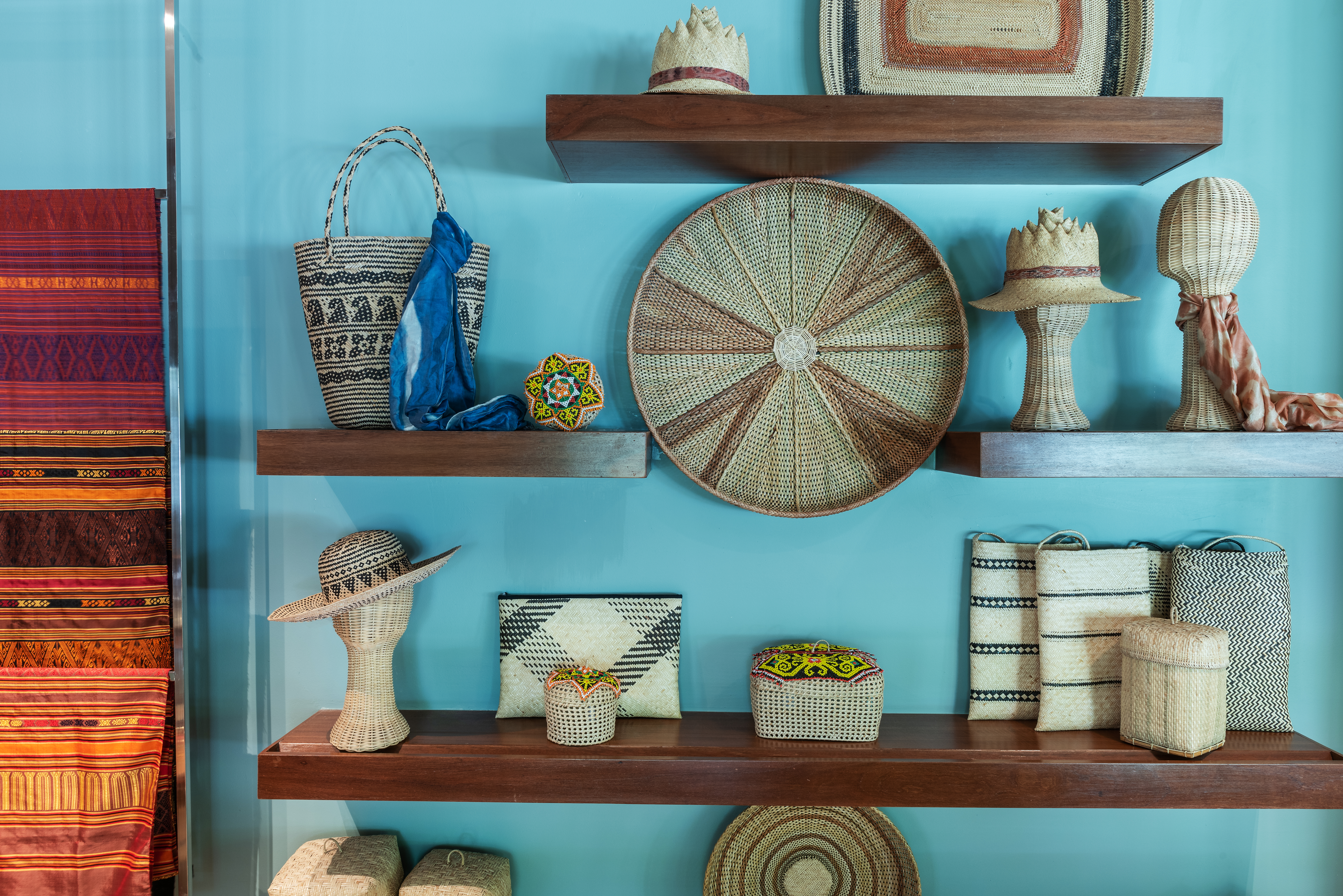 arts and crafts on multiple shelfs on a light blue wall