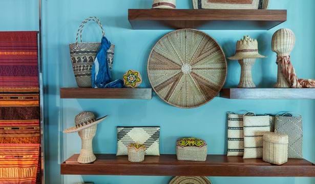 arts and crafts on multiple shelfs on a light blue wall