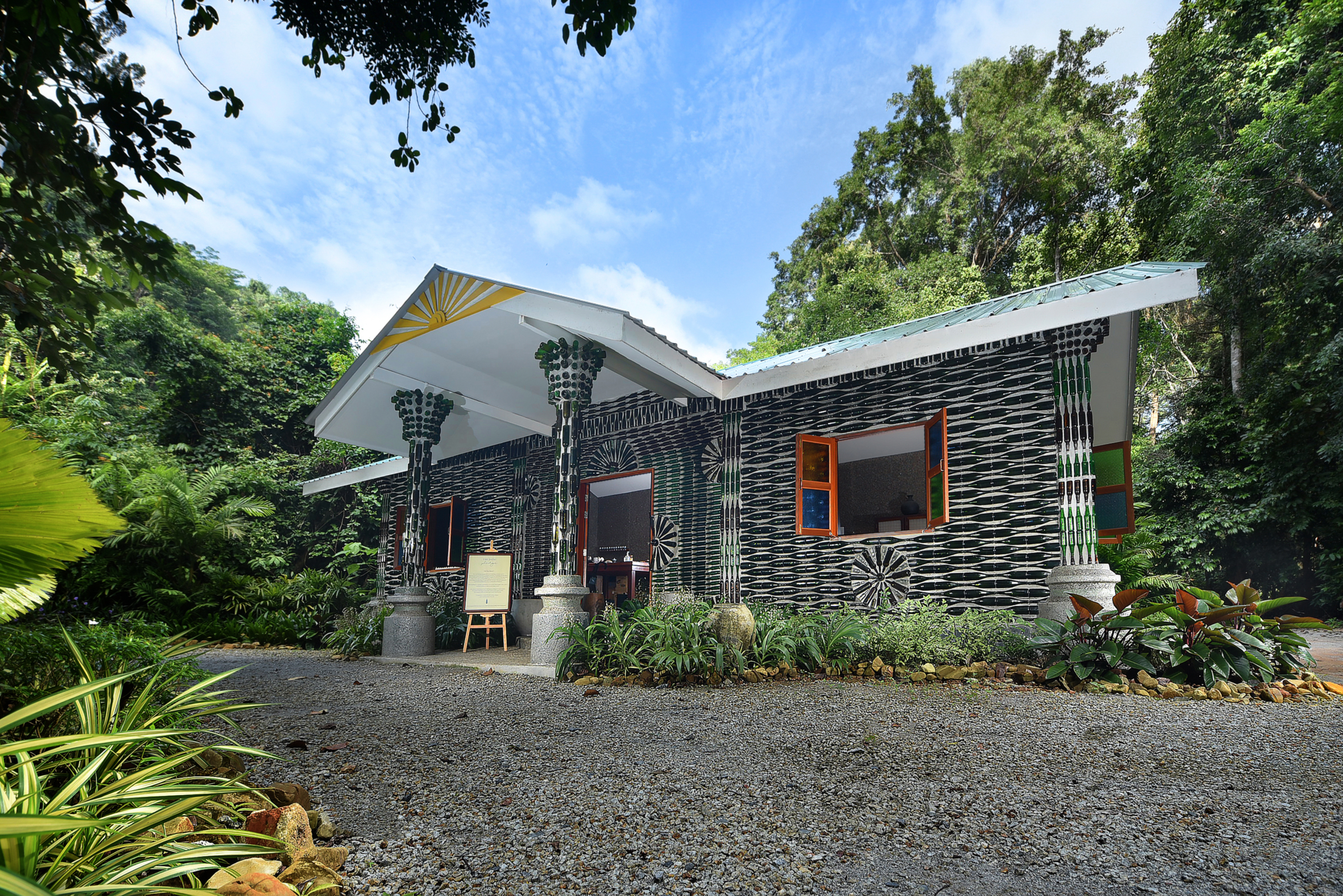 front entrance to the lab building decorated with black and white walls with a gravel path leading to it