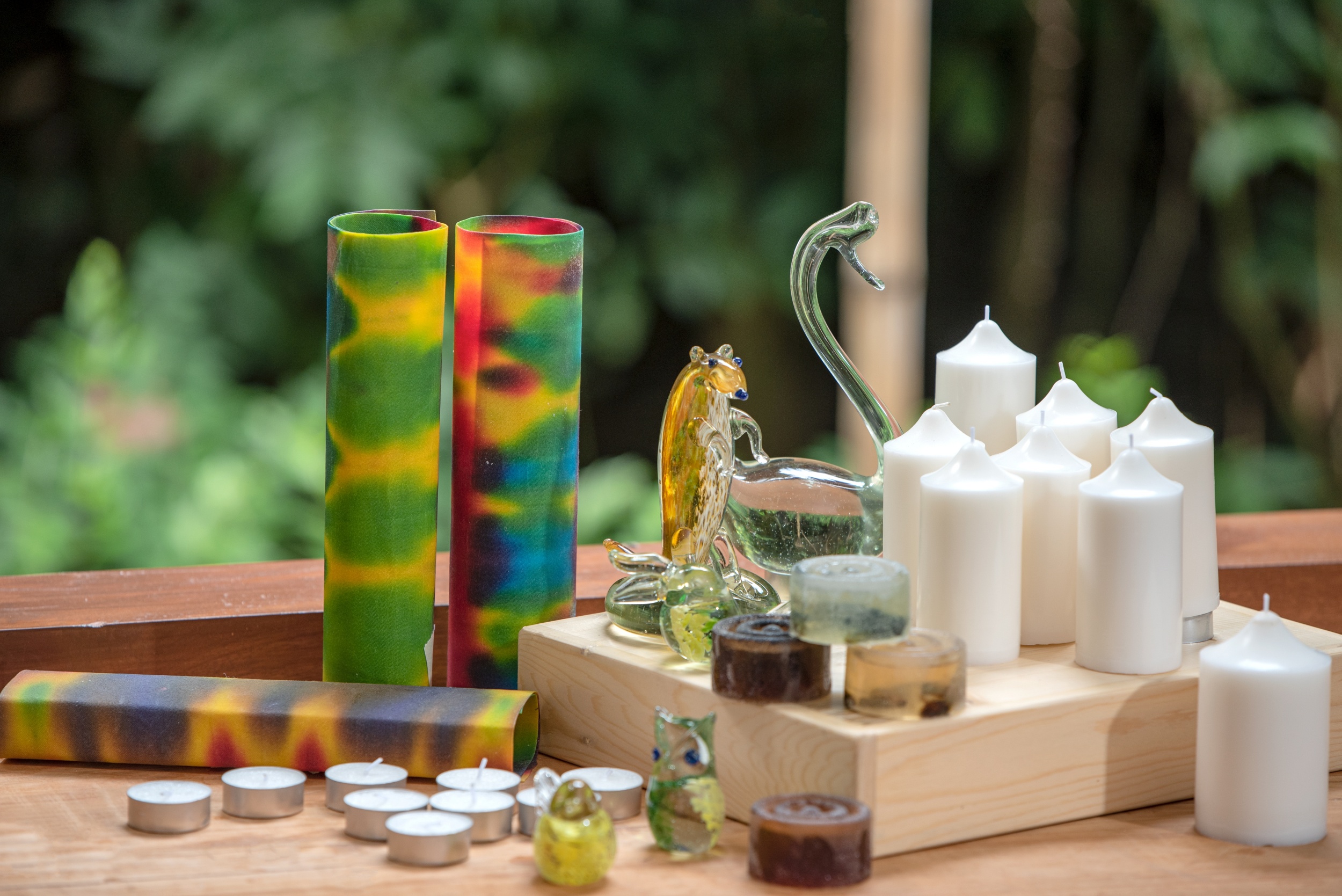 decorated glass animals and candles on a wooden table