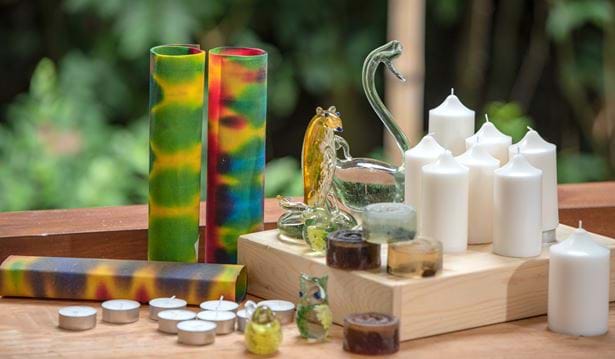 decorated glass animals and candles on a wooden table