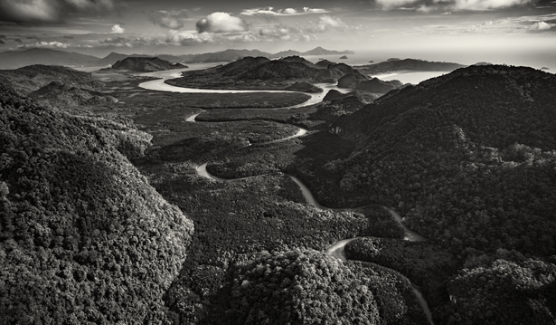 wide black and white photo showcasing the landscape of Langkawi with meandering river, rainforests and a mountain 