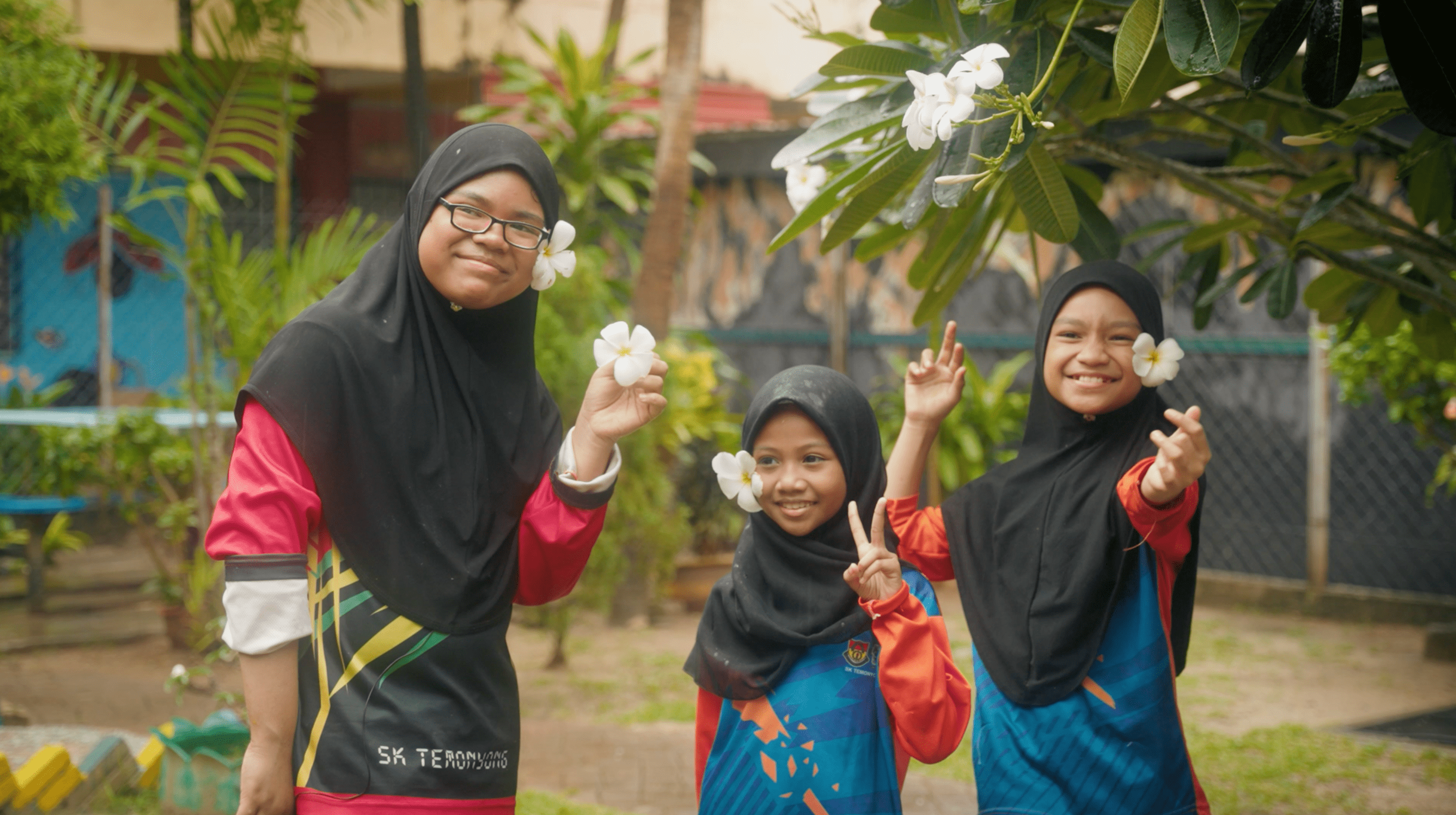 three ladies holding flowers